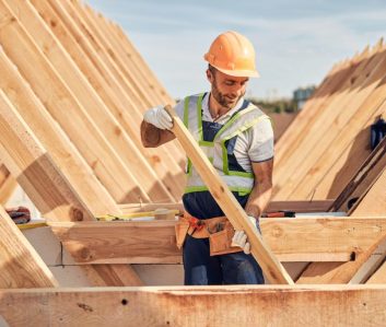 focused-builder-is-adjusting-a-wooden-bar-to-a-roof-carcass-1024x682-1.jpg