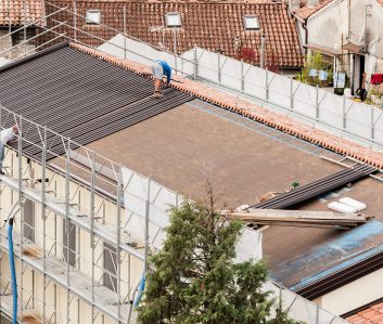 Workers in the construction of a roof.  Building renovation.