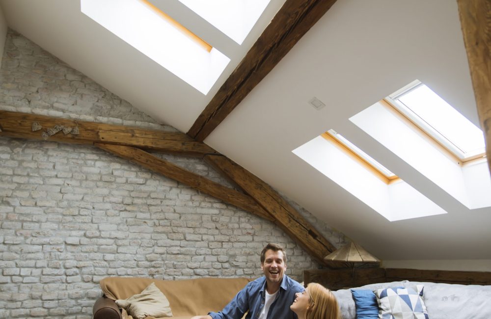 Young couple using tablet sitting on the floor at home Happy young couple using tablet sitting on the floor at home